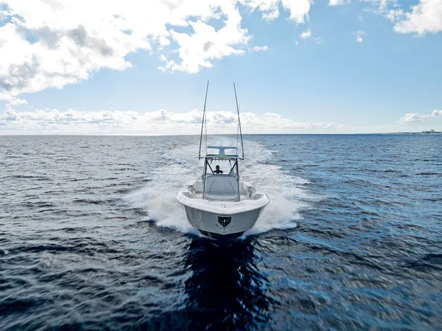 Slide: The Image of 2021 Contender 44 ST boat with four powerful outboard engines docked at marina. - 21