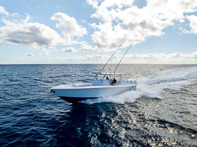 Slide: The Image of 2021 Contender 44 ST boat interior with red seating, marina view, and blue sky. - 22
