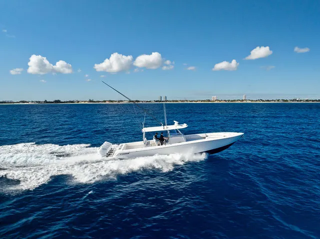 Slide: The Image of 2021 Contender 44 ST boat interior with red accents at marina dock. - 23