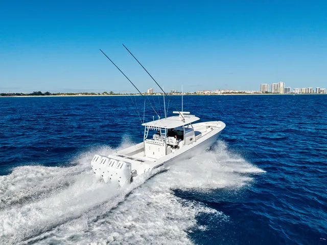 Slide: The Image of 2021 Contender 44 ST boat with open storage compartment and cooler on deck. - 24