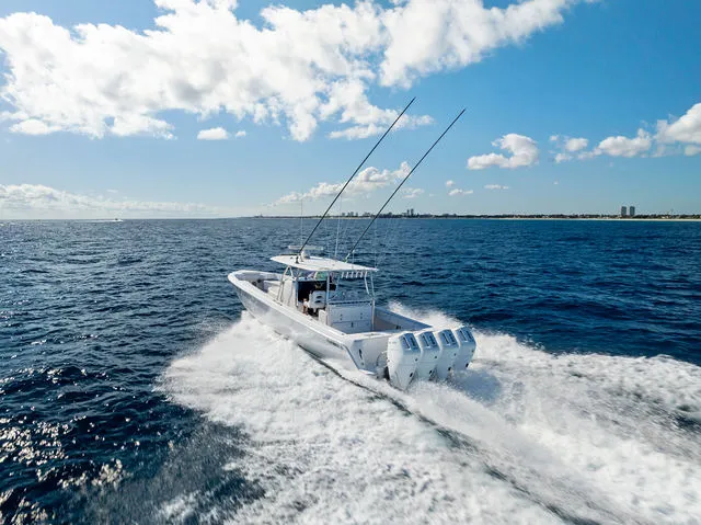 Slide: The Image of 2021 Contender 44 ST boat with four powerful Mercury outboard engines docked at marina. - 26