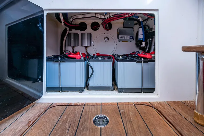 Slide: The Image of Battery compartment of 2021 Contender 44 ST boat, showcasing electrical components and wiring. - 28