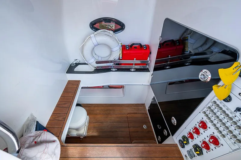 Slide: The Image of 2021 Contender 44 ST boat interior with wooden flooring, life preserver, and control panel. - 29