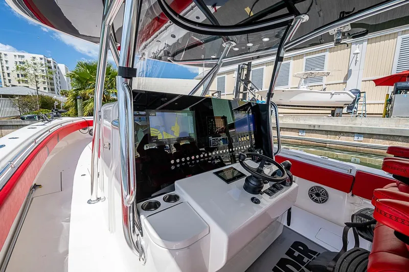 Slide: The Image of 2021 Contender 44 ST boat cockpit with advanced navigation system and sleek design. - 31