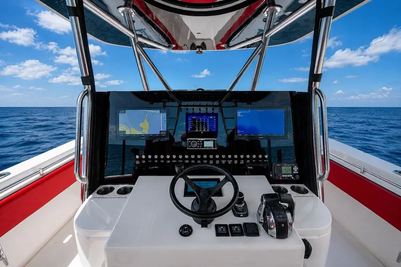 Slide: The Image of 2021 Contender 44 ST boat cockpit with advanced navigation displays and controls. - 36
