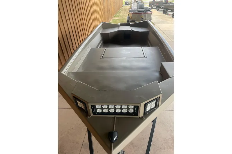 Slide: The Image of 2026 Reaper Boats 653 Timber Reaper with LED lights, sleek design, and spacious deck. - 10