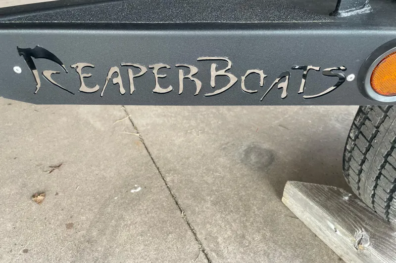 Slide: The Image of Reaper Boats logo on 2026 Reaper Boats 653 Timber Reaper trailer. - 11