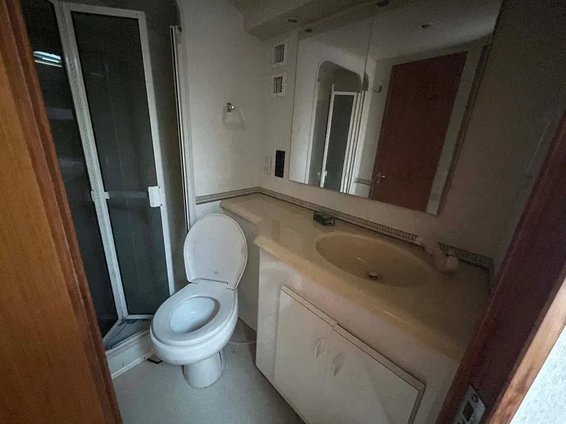 Slide: The Image of Bathroom interior of 1998 Viking 50 Convertible yacht with shower and vanity. - 13