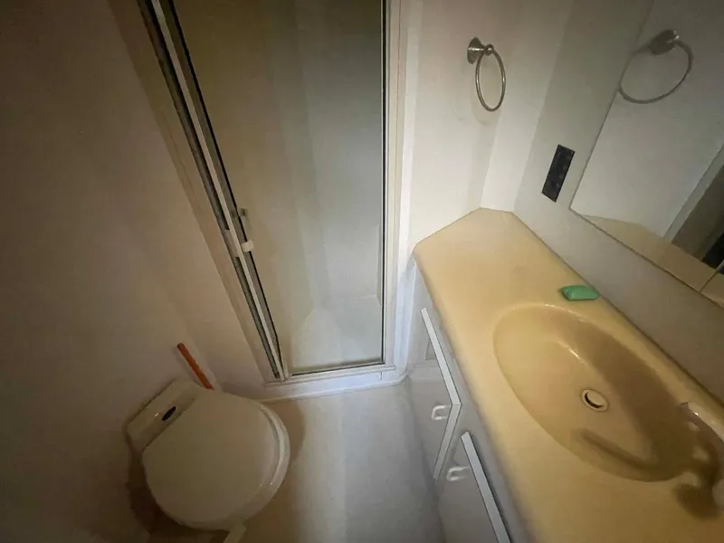 Slide: The Image of Bathroom interior of 1998 Viking 50 Convertible yacht with shower, sink, and toilet. - 16