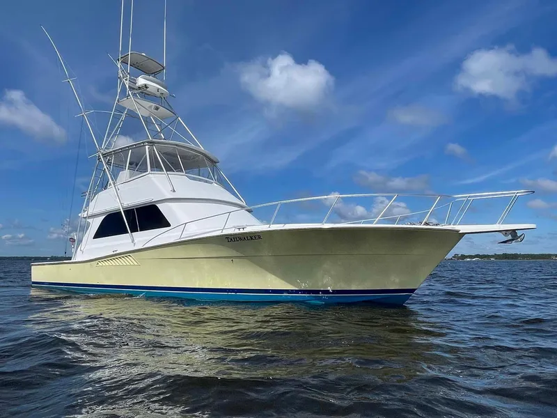 Slide: The Image of 1998 Viking 50 Convertible yacht on calm water under blue sky. - 17