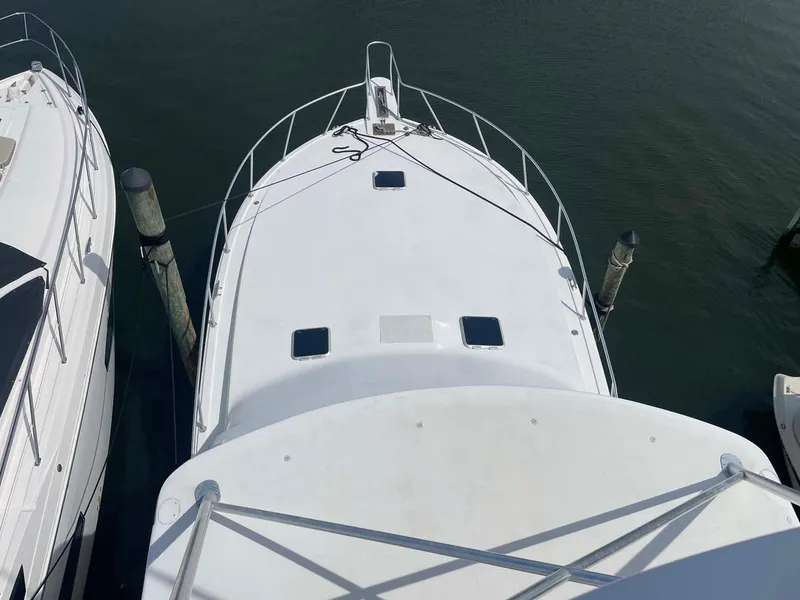 Slide: The Image of Overhead view of a 1998 Viking 50 Convertible yacht docked at a marina. - 20
