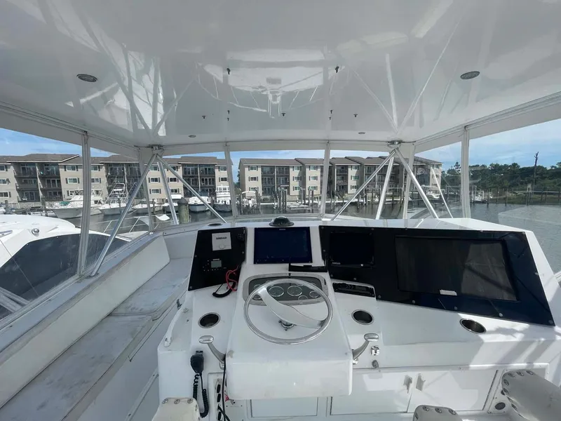 Slide: The Image of Helm of 1998 Viking 50 Convertible yacht with modern navigation equipment. - 22