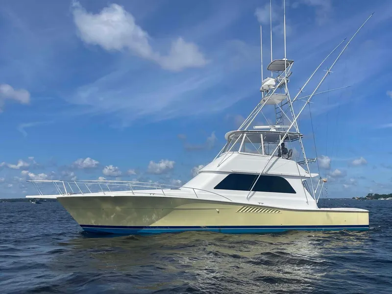 Slide: The Image of 1998 Viking 50 Convertible yacht on open water under blue sky. - 3
