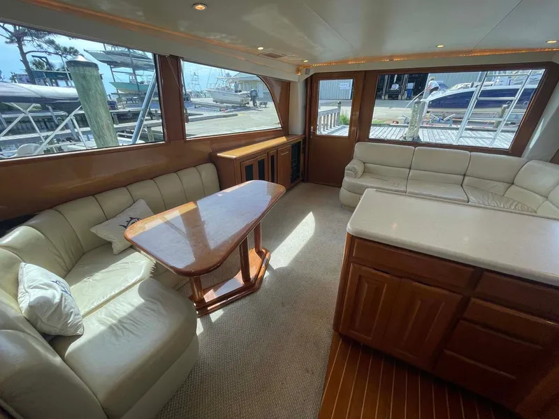 Slide: The Image of Luxurious interior of a 1998 Viking 50 Convertible yacht with plush seating and wooden accents. - 4