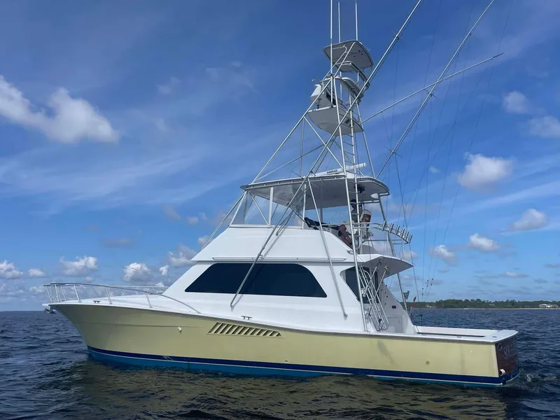 Slide: The Image of 1998 Viking 50 Convertible yacht on open water under blue sky. - 42