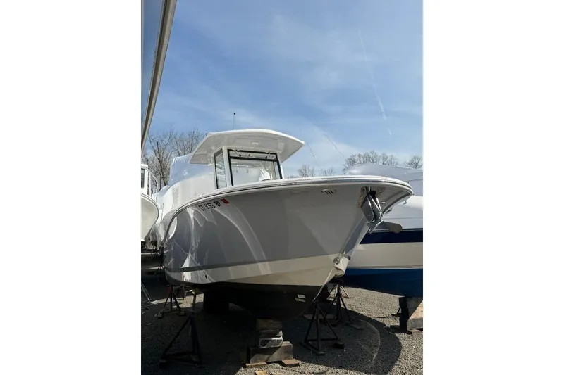 The Image of 2024 Robalo R250 Center Console boat on display under clear blue sky. - 0