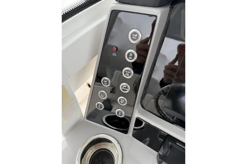 Slide: The Image of Control panel of 2024 Robalo R250 Center Console boat with various function buttons. - 11