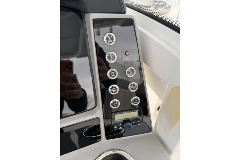 Slide: The Image of 2024 Robalo R250 Center Console dashboard with control panel and buttons. - 13