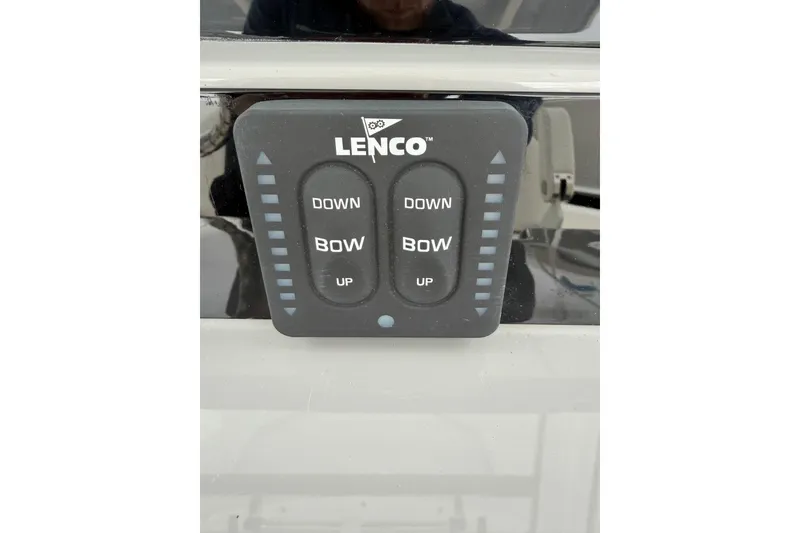 Slide: The Image of Lenco trim tab control on 2024 Robalo R250 Center Console boat dashboard. - 14