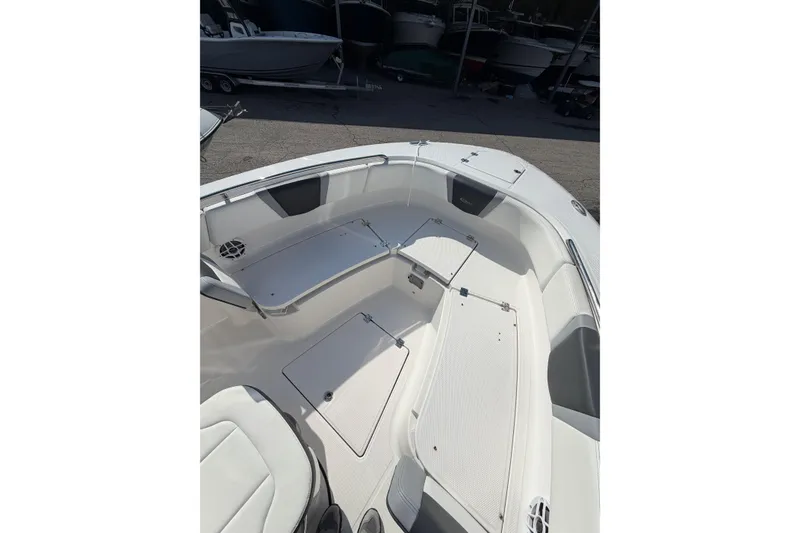 Slide: The Image of 2024 Robalo R250 Center Console boat interior with seating and storage compartments. - 17