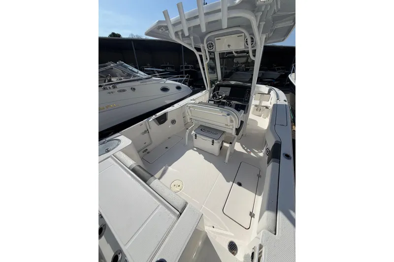 Slide: The Image of 2024 Robalo R250 Center Console boat interior with helm, seating, and storage compartments. - 4