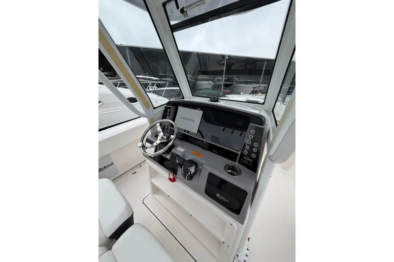 Slide: The Image of 2024 Robalo R250 Center Console boat dashboard with Garmin navigation system. - 9