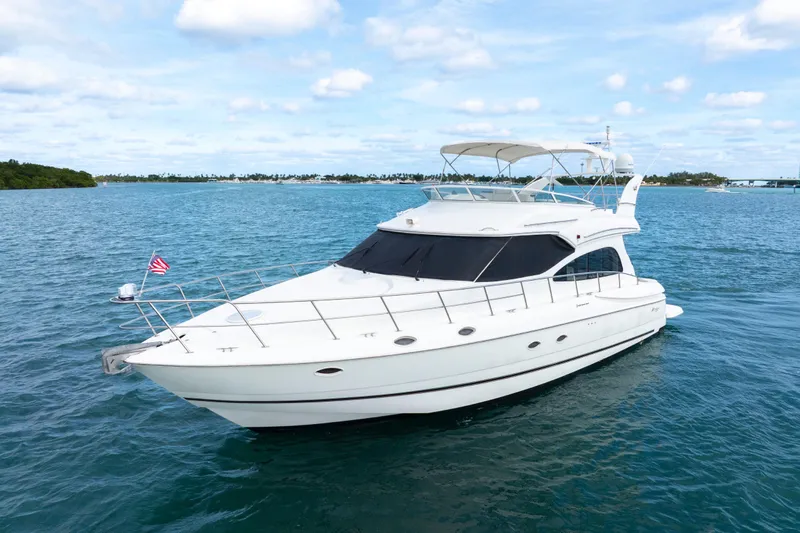 Slide: The Image of 2001 Cruisers Yachts 5000 Sedan Sport on blue ocean under clear sky. - 11