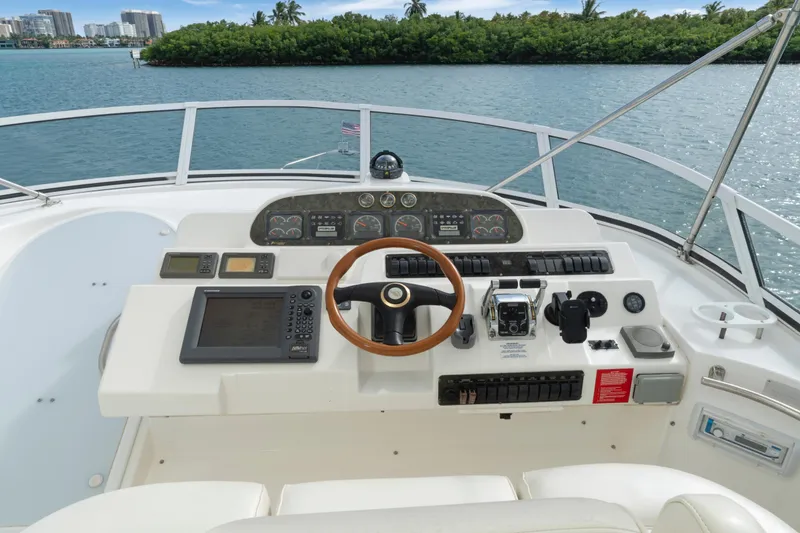 Slide: The Image of 2001 Cruisers Yachts 5000 Sedan Sport helm with steering wheel and navigation controls. - 27