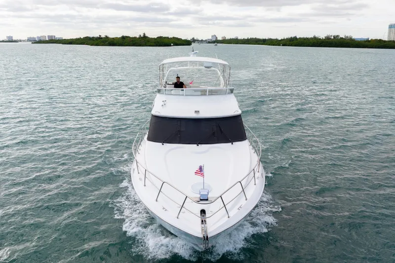 Slide: The Image of 2001 Cruisers Yachts 5000 Sedan Sport cruising on open water, front view. - 3