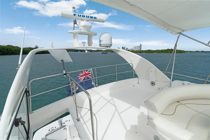 Slide: The Image of 2001 Cruisers Yachts 5000 Sedan Sport on water, featuring spacious deck and radar equipment. - 30