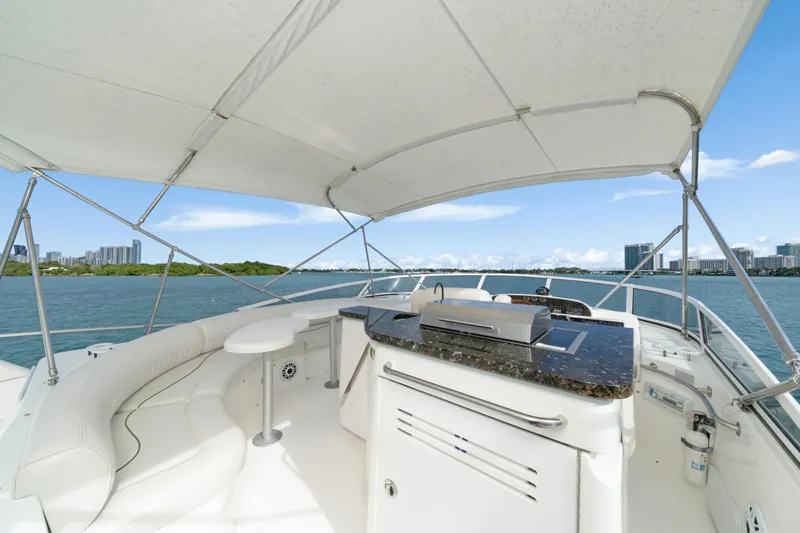 Slide: The Image of 2001 Cruisers Yachts 5000 Sedan Sport, luxurious deck view with seating and grill. - 32