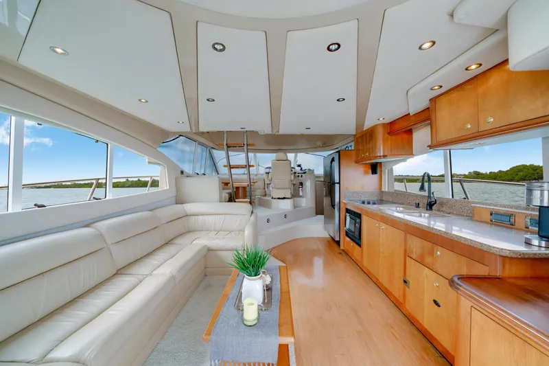Slide: The Image of Luxurious interior of 2001 Cruisers Yachts 5000 Sedan Sport with modern kitchen and seating area. - 38