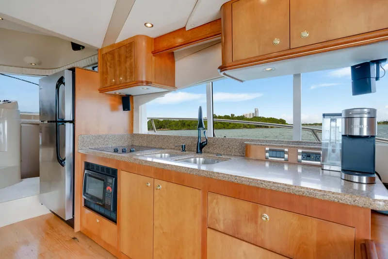 Slide: The Image of Luxurious kitchen interior of 2001 Cruisers Yachts 5000 Sedan Sport with modern appliances. - 39