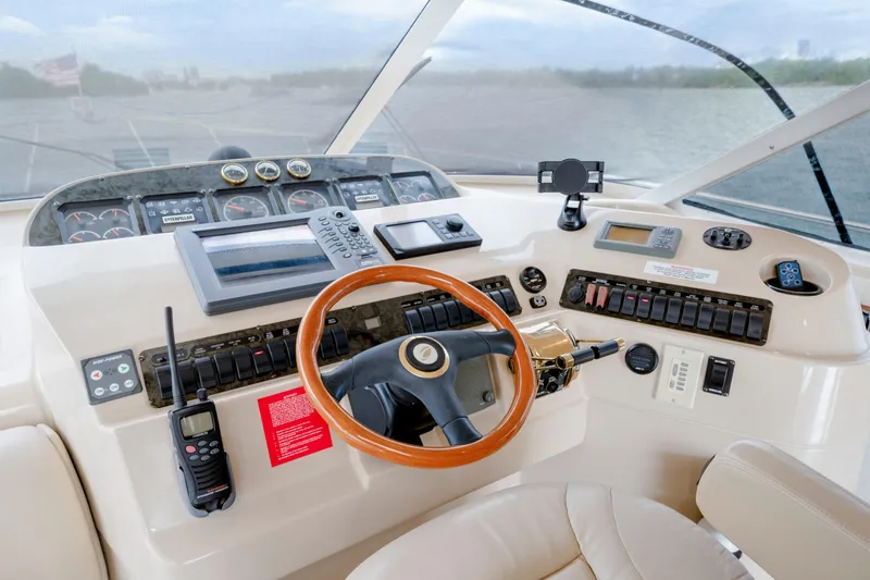 Slide: The Image of Cockpit of 2001 Cruisers Yachts 5000 Sedan Sport with steering wheel and control panel. - 44