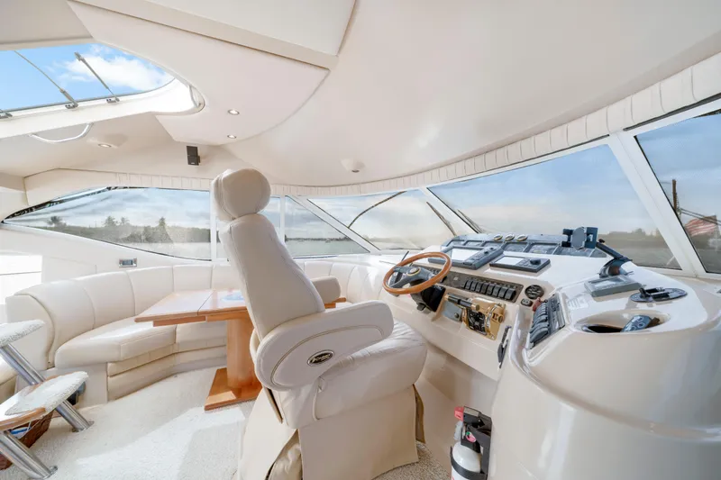 Slide: The Image of Luxurious interior of 2001 Cruisers Yachts 5000 Sedan Sport with helm and seating area. - 46