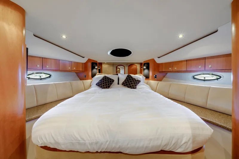 Slide: The Image of Luxurious bedroom interior of 2001 Cruisers Yachts 5000 Sedan Sport with elegant wood finish. - 52