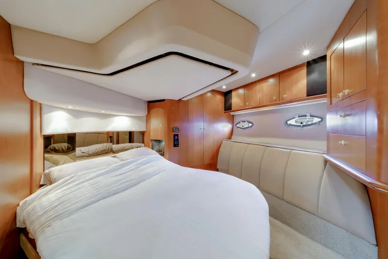 Slide: The Image of Luxurious bedroom interior of 2001 Cruisers Yachts 5000 Sedan Sport with wood cabinetry. - 53