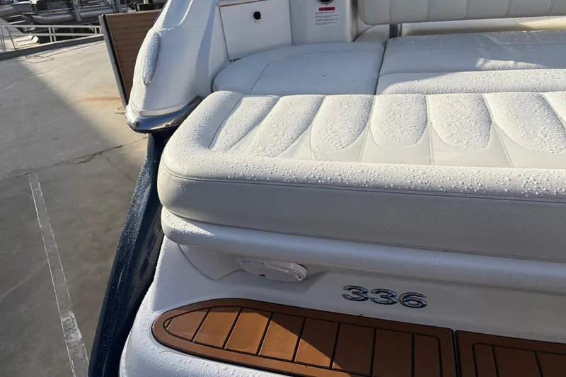 Slide: The Image of 2015 Cobalt 336 boat with white cushioned seating and wooden deck accents. - 10