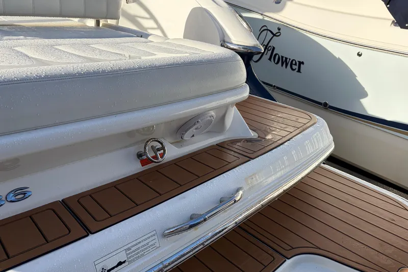 Slide: The Image of 2015 Cobalt 336 boat with teak deck and cushioned seating, docked beside another vessel. - 11