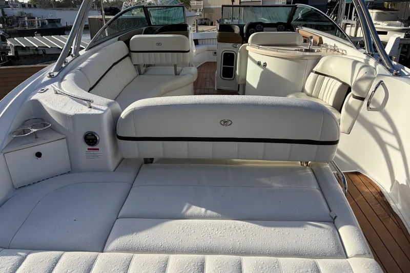 Slide: The Image of 2015 Cobalt 336 boat interior with white seating and wooden deck. - 14