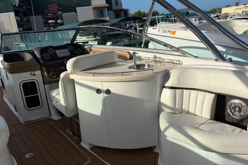 Slide: The Image of Interior of a 2015 Cobalt 336 boat featuring a helm, seating, and wet bar. - 18
