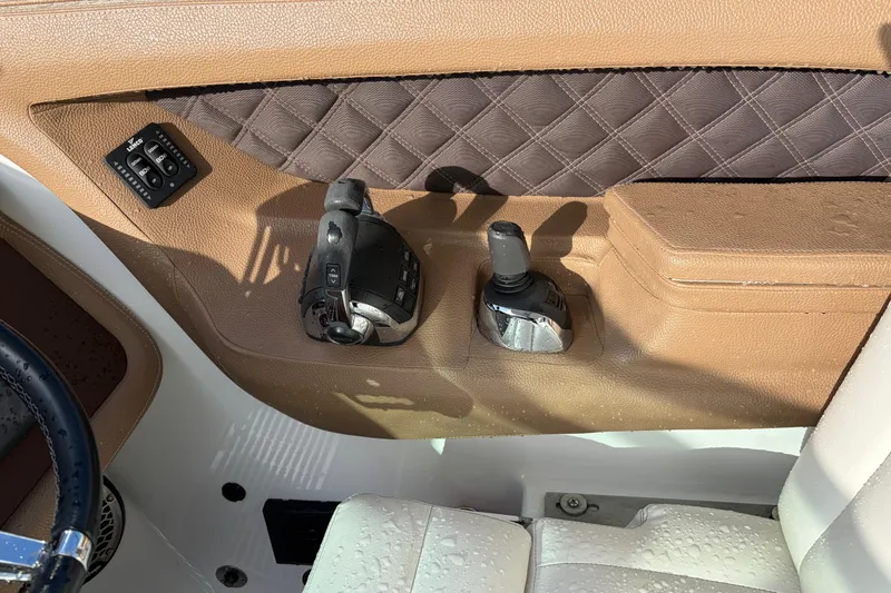 Slide: The Image of Interior of a 2015 Cobalt 336 boat with control panel and joystick. - 22