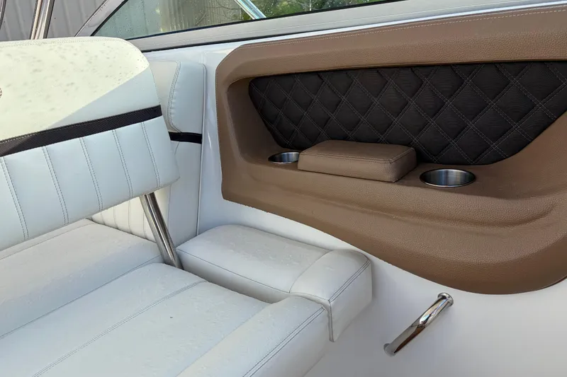 Slide: The Image of Luxurious interior of a 2015 Cobalt 336 boat with white and brown seating. - 24