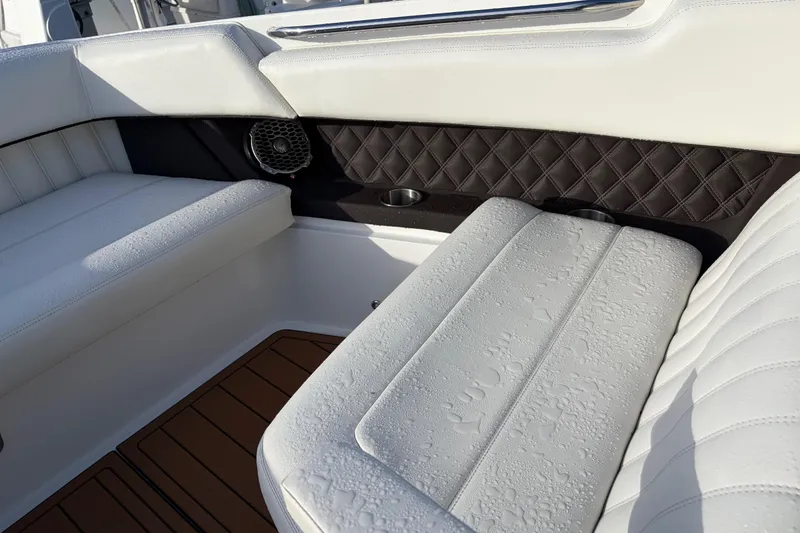 Slide: The Image of Luxurious seating in a 2015 Cobalt 336 boat, featuring white upholstery and elegant design. - 25
