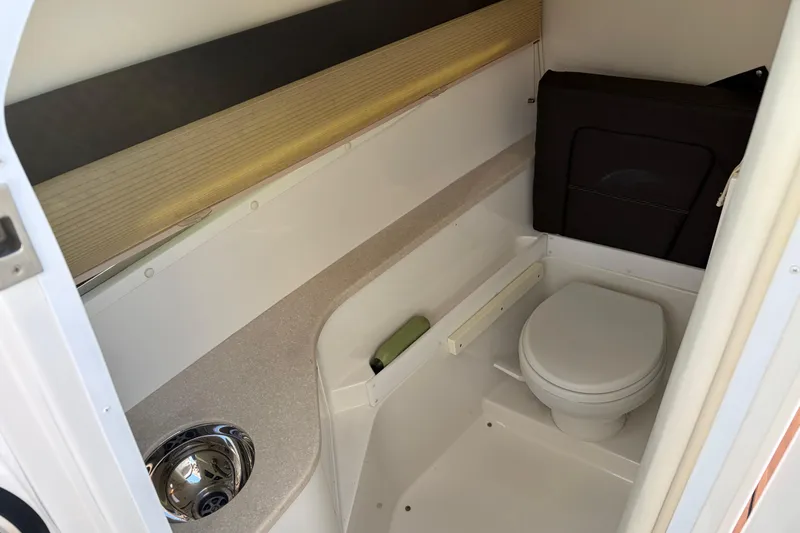 Slide: The Image of 2015 Cobalt 336 boat interior bathroom with toilet and sink. - 26