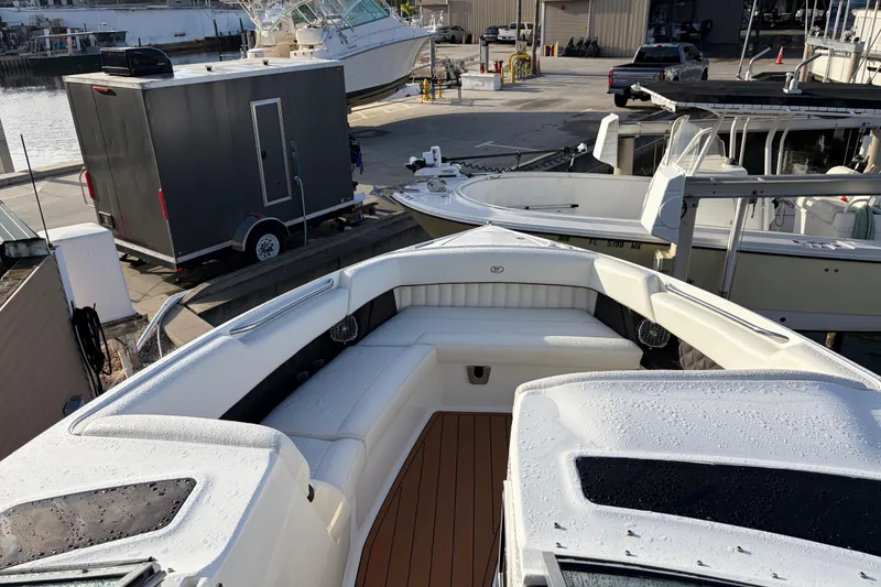 Slide: The Image of 2015 Cobalt 336 boat with sleek seating, docked at a marina. - 29
