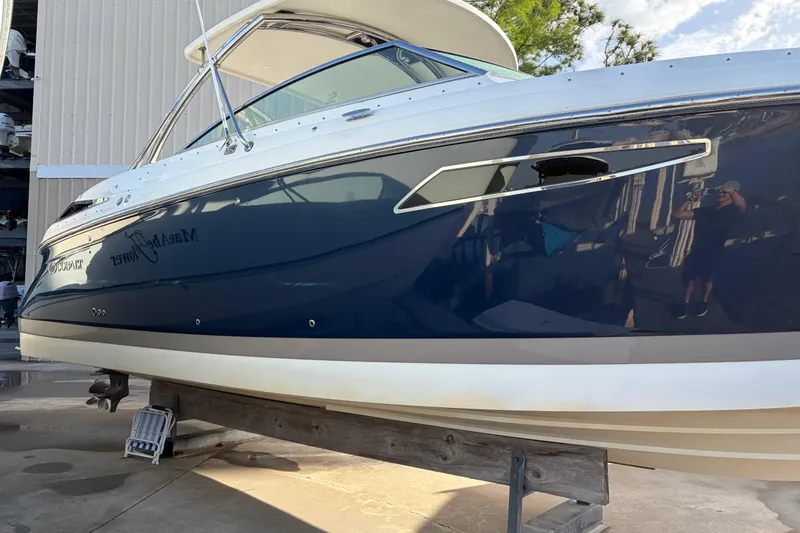 Slide: The Image of 2015 Cobalt 336 boat with sleek blue and white design on display. - 3