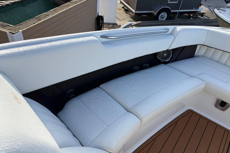 Slide: The Image of Luxurious seating on a 2015 Cobalt 336 boat, featuring white upholstery and teak flooring. - 30