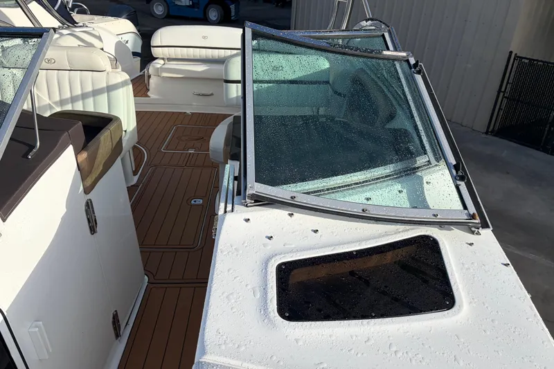 Slide: The Image of 2015 Cobalt 336 boat interior with wet windshield and teak flooring. - 35
