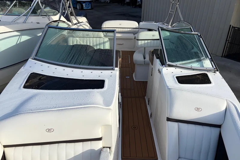 Slide: The Image of 2015 Cobalt 336 boat interior with white seating and wooden flooring. - 36